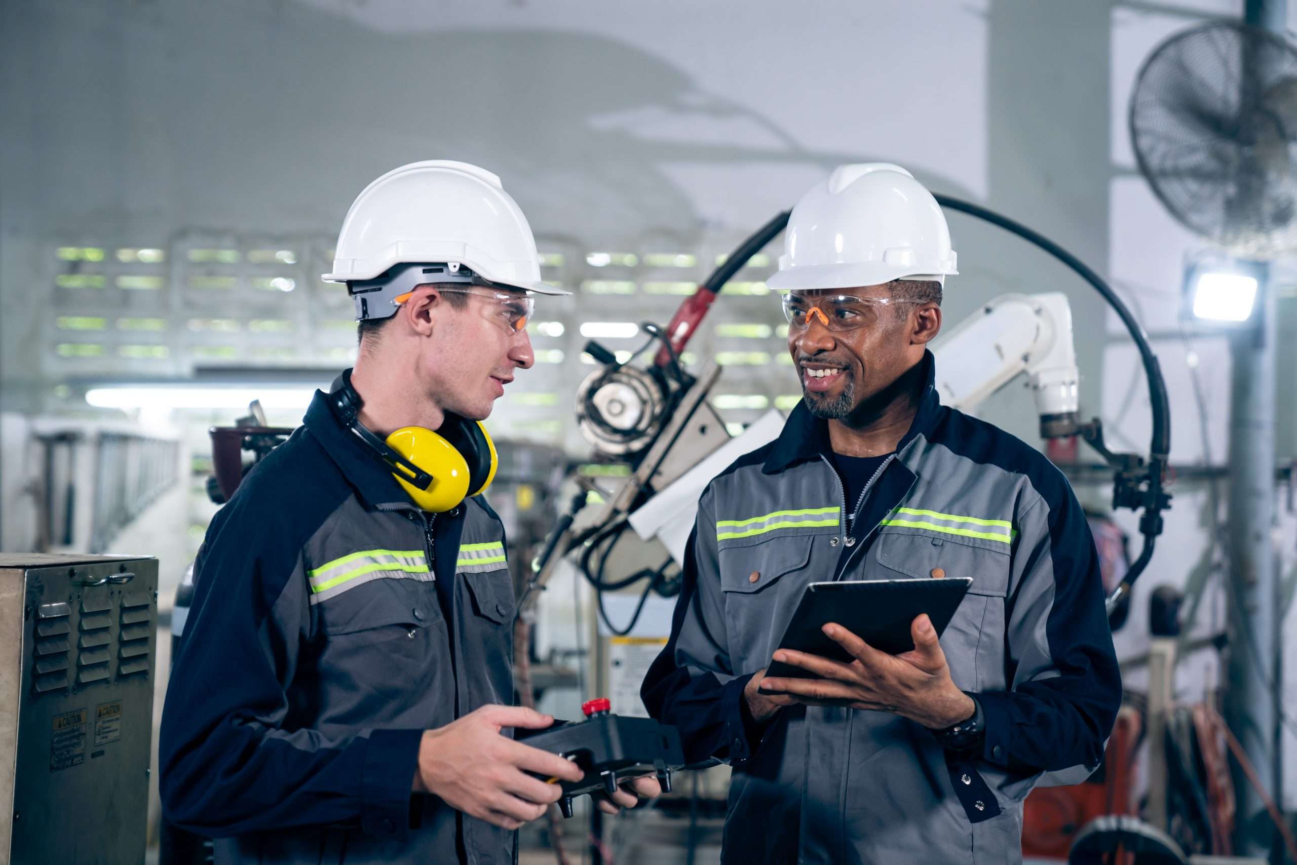 Group Of Factory Job Workers Using Adept Machine Equipment In A Workshop